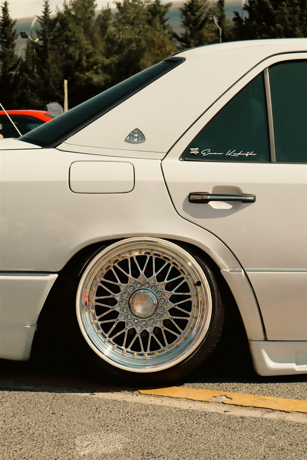 Custom polished multi-spoke alloy wheel on a modified car